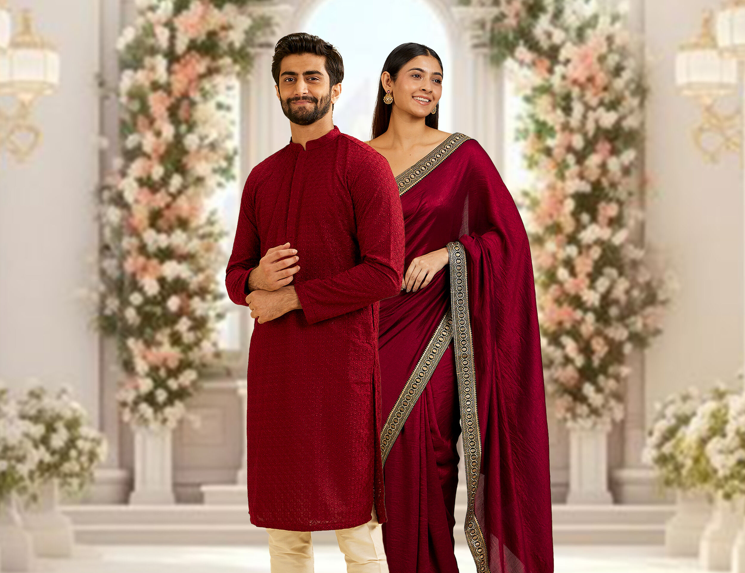 A grromsmen in red kurta pajama and bridesmaid in red saree